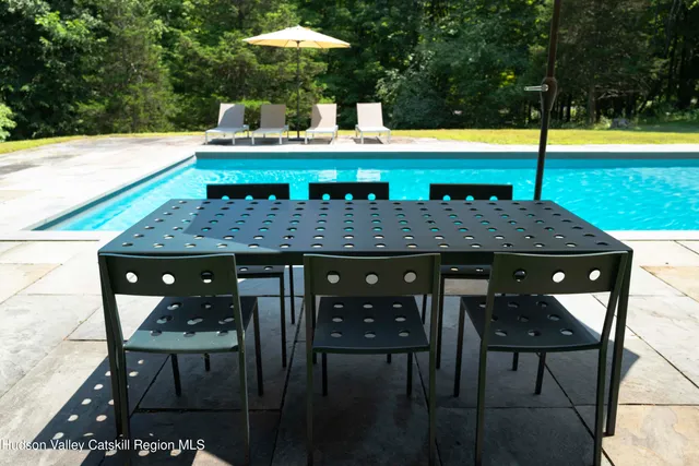 a view of a chairs and table on the deck