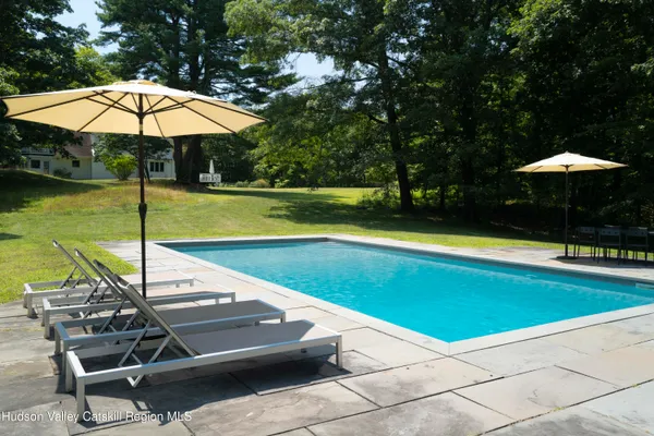 a view of a swimming pool with lounge chairs