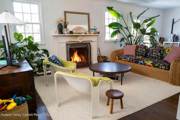 a living room with furniture a chandelier and a fireplace