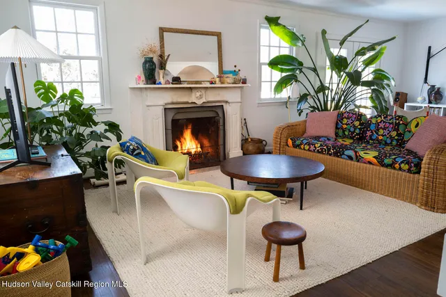 a living room with furniture a chandelier and a fireplace