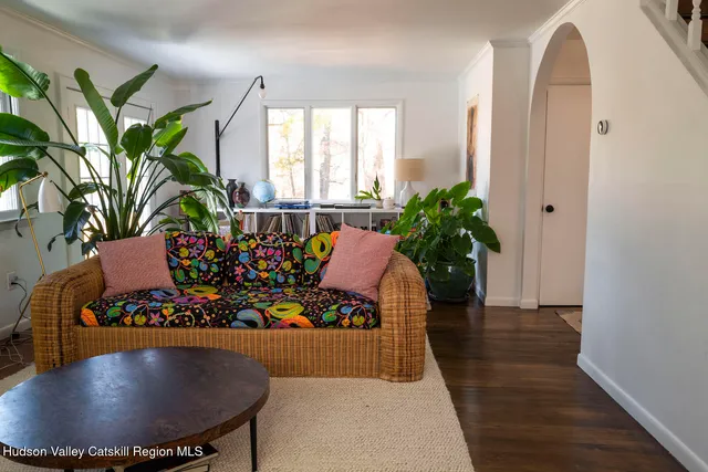 a living room filled with furniture and flowers