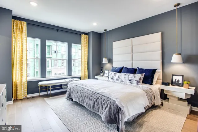 a bedroom with a bed and a large window