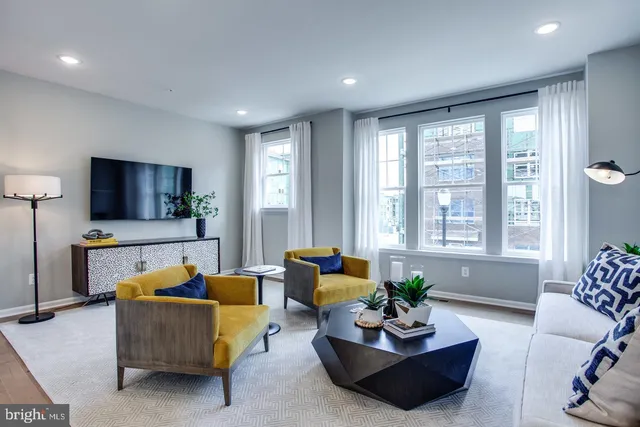 a living room with furniture and a large window