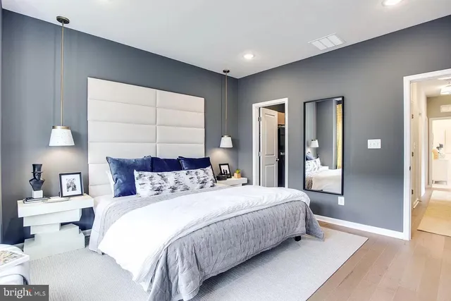 a bedroom with a bed and a lamp