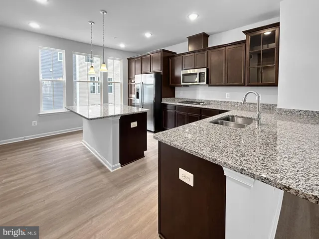 a kitchen with stainless steel appliances granite countertop a sink and a granite counter tops