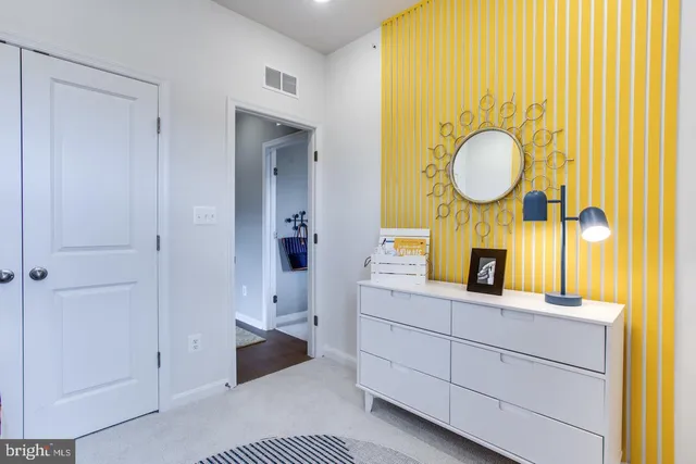 a bedroom with a bed and a dresser