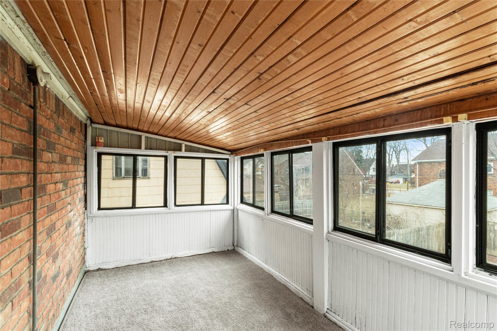 4834 Devonshire Road Detroit, MI 48224 - Photo 19 of 22 Unfurnished sunroom featuring vaulted ceiling and healthy amount of natural light