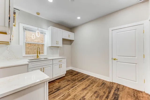 a kitchen with a sink stove and cabinets