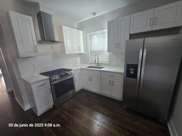 a kitchen with stainless steel appliances a refrigerator sink and stove