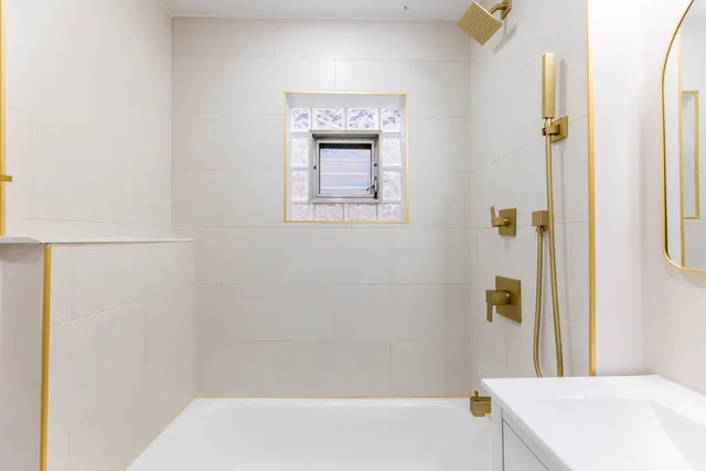 a bathroom with a bathtub and shower