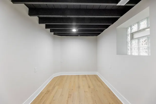 a bathroom with a toilet a sink a mirror and vanity