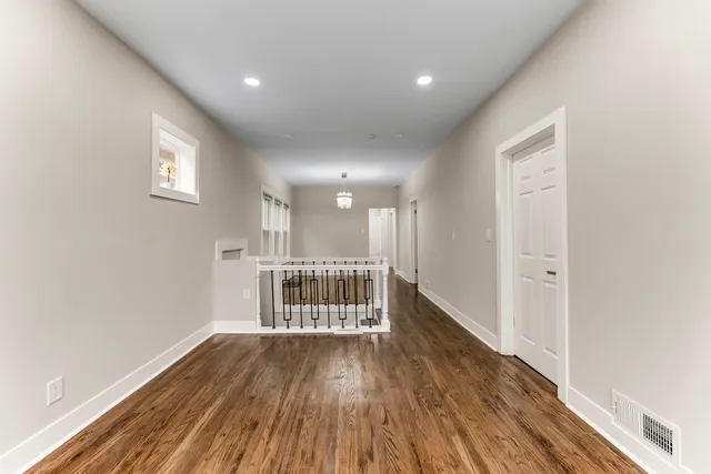 a view of wooden floor and windows in a room