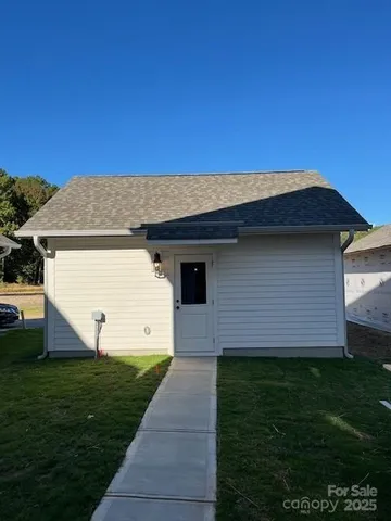 a view of a white house with a yard
