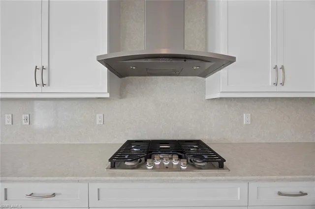 a close view of a stove a microwave and cabinets