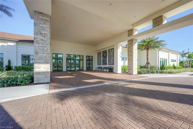 a living room with fireplace furniture and a chandelier