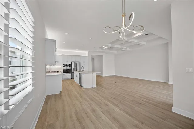 a view of kitchen with sink and wooden floor