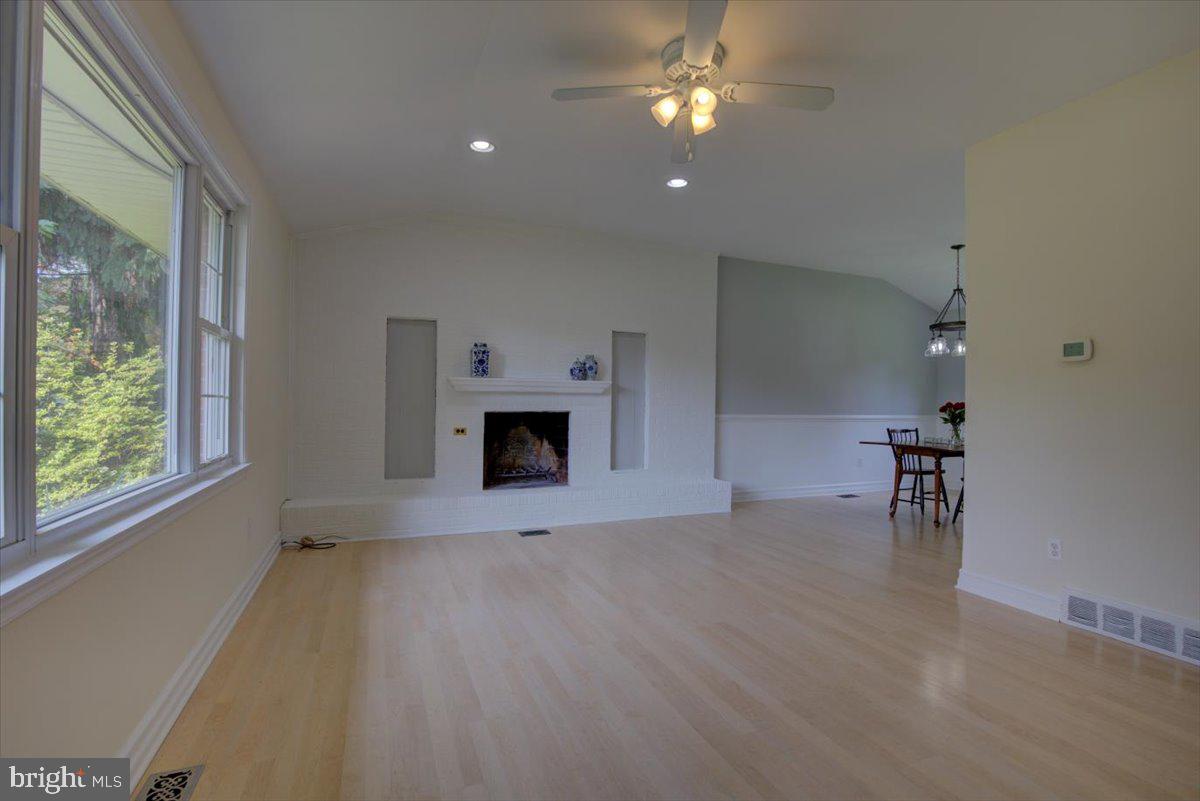124 Conestoga Road Malvern, PA 19355 - Photo 6 of 34 Living room with feature brick wall and fireplace