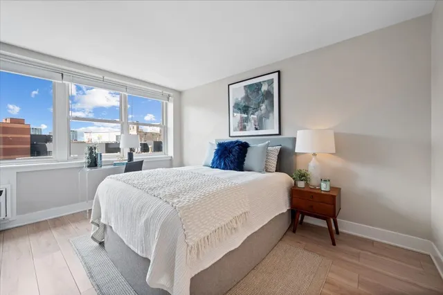 a bedroom with a bed and a large window