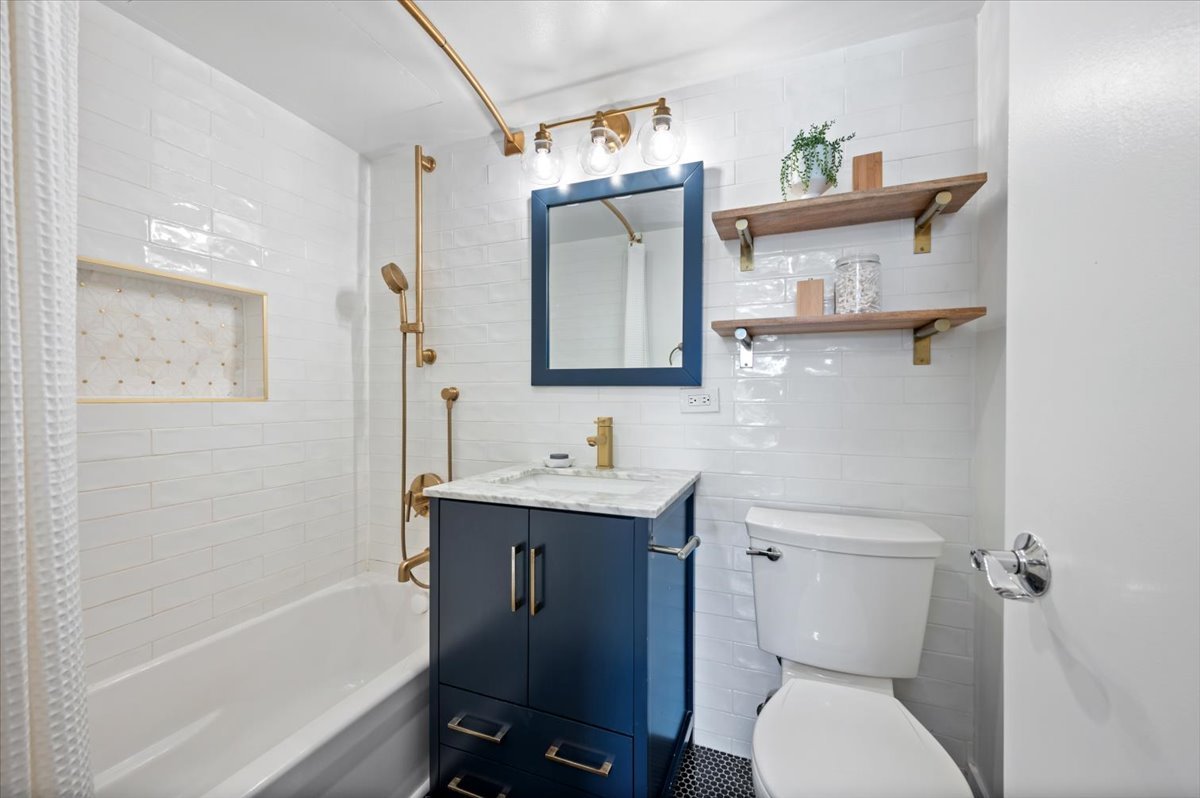 2300 North Commonwealth Avenue, Unit 7J Chicago, IL 60614 - Photo 16 of 20 a bathroom with a toilet a sink and mirror