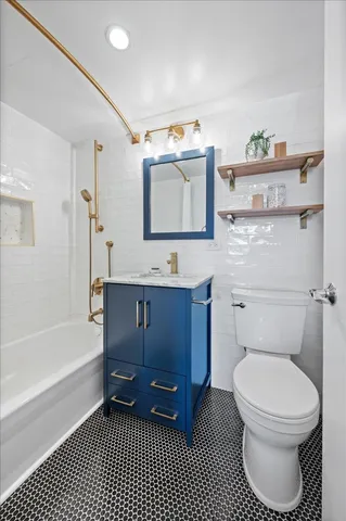 a bathroom with a toilet a sink and bathtub