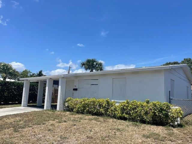 1104 West 24th Street Riviera Beach, FL 33404 - Photo 3 of 18 a front view of a house with a yard