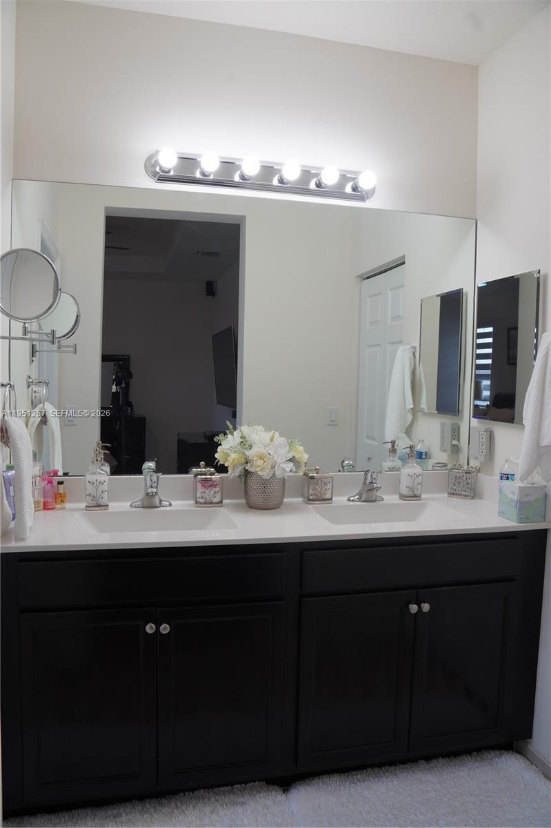 10306 West 33rd Lane Hialeah, FL 33018 - Photo 14 of 29 a bathroom with a double vanity sink and a mirror