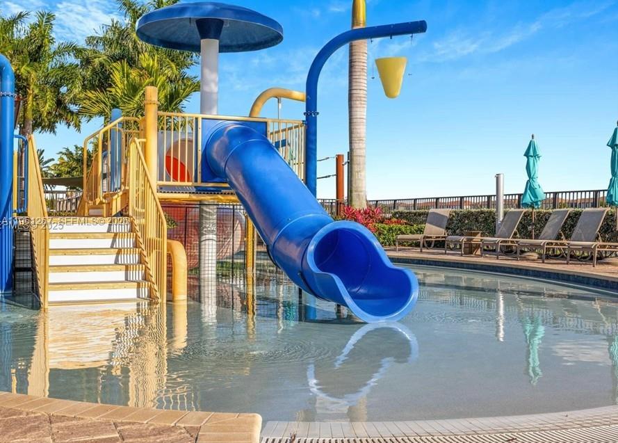 10306 West 33rd Lane Hialeah, FL 33018 - Photo 25 of 29 a view of a swimming pool with a lounge chairs