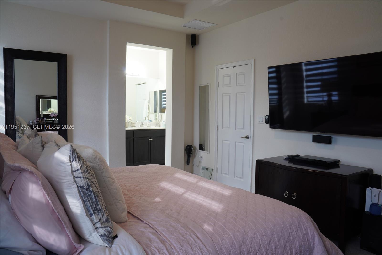 10306 West 33rd Lane Hialeah, FL 33018 - Photo 8 of 29 a bedroom with a bed tv and window