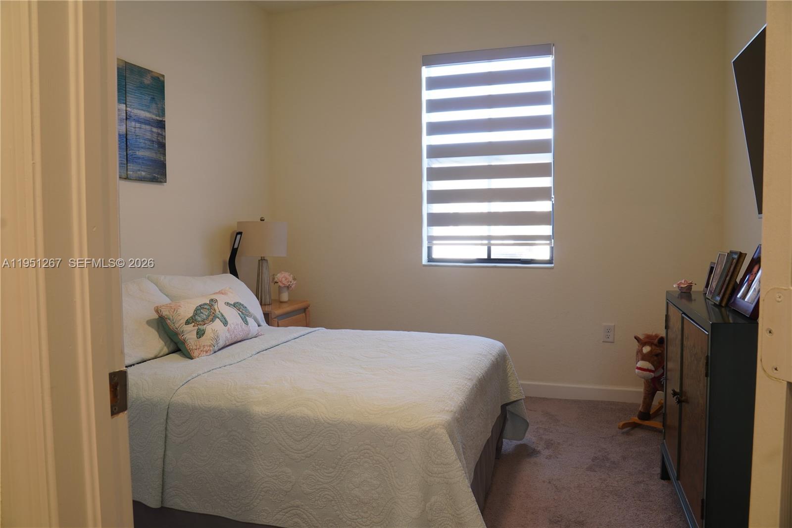 10306 West 33rd Lane Hialeah, FL 33018 - Photo 9 of 29 a bedroom with a bed and a window