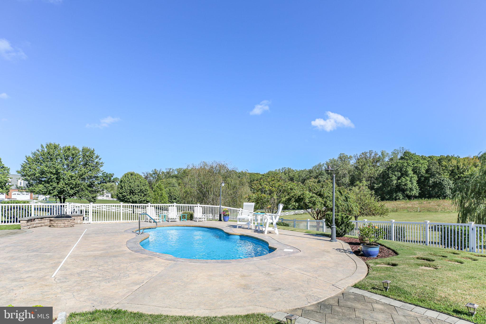 9910 Agnes Lane Spotsylvania, VA 22553 - Photo 102 of 106 a view of a swimming pool with a patio