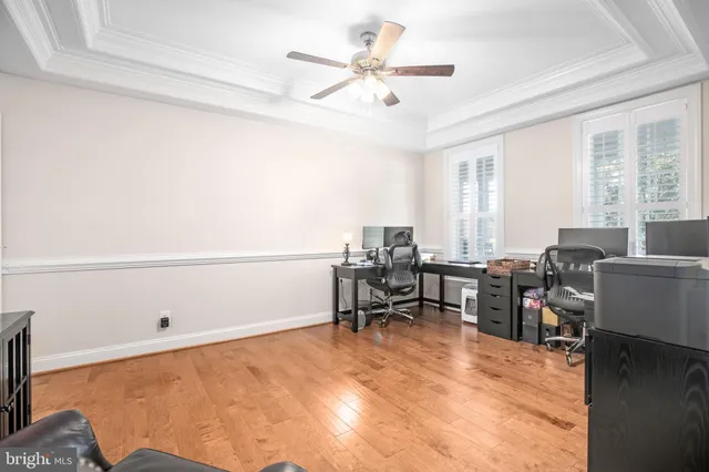 a bedroom with a bed and ceiling fan