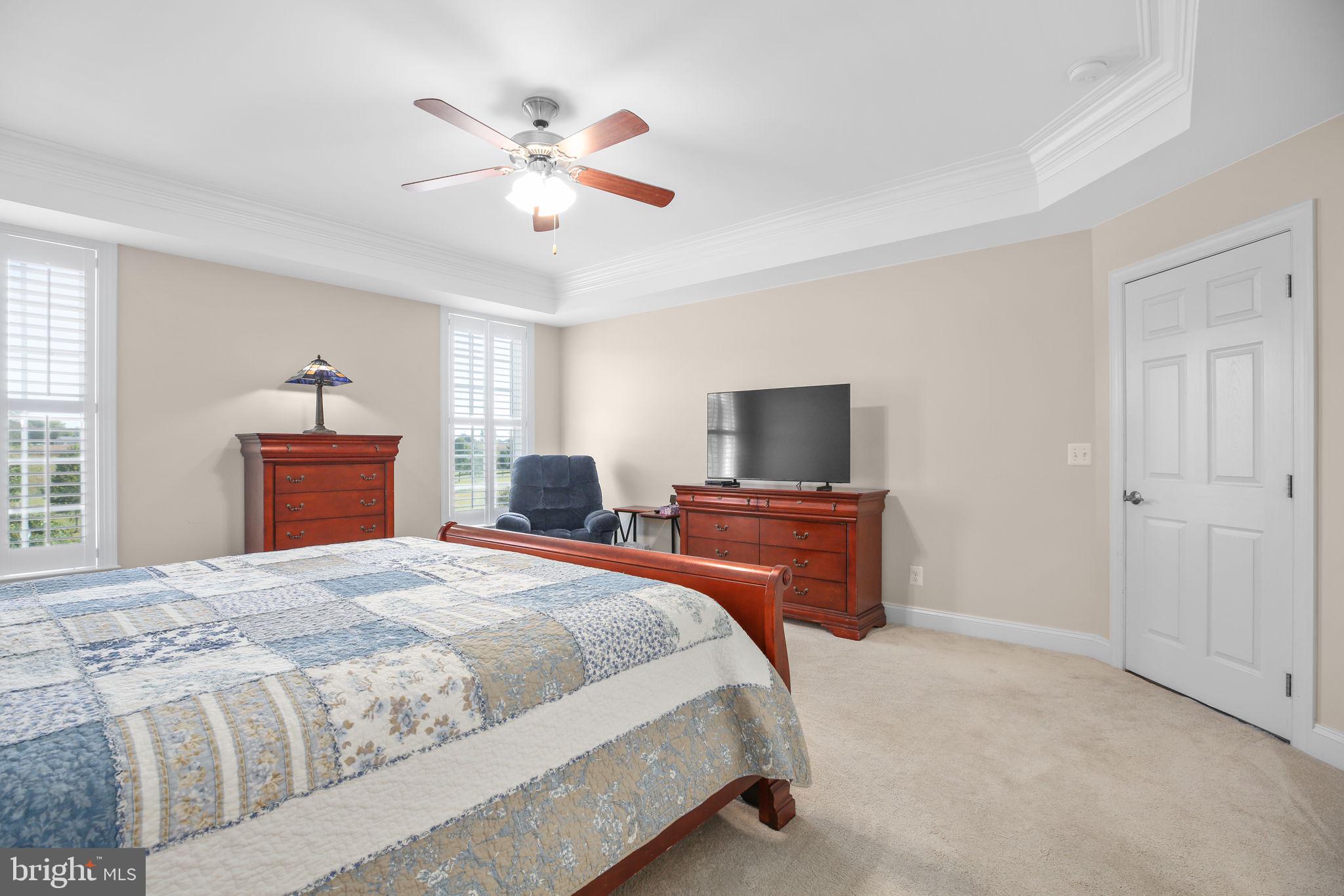 9910 Agnes Lane Spotsylvania, VA 22553 - Photo 30 of 106 a bedroom with a bed and a chandelier