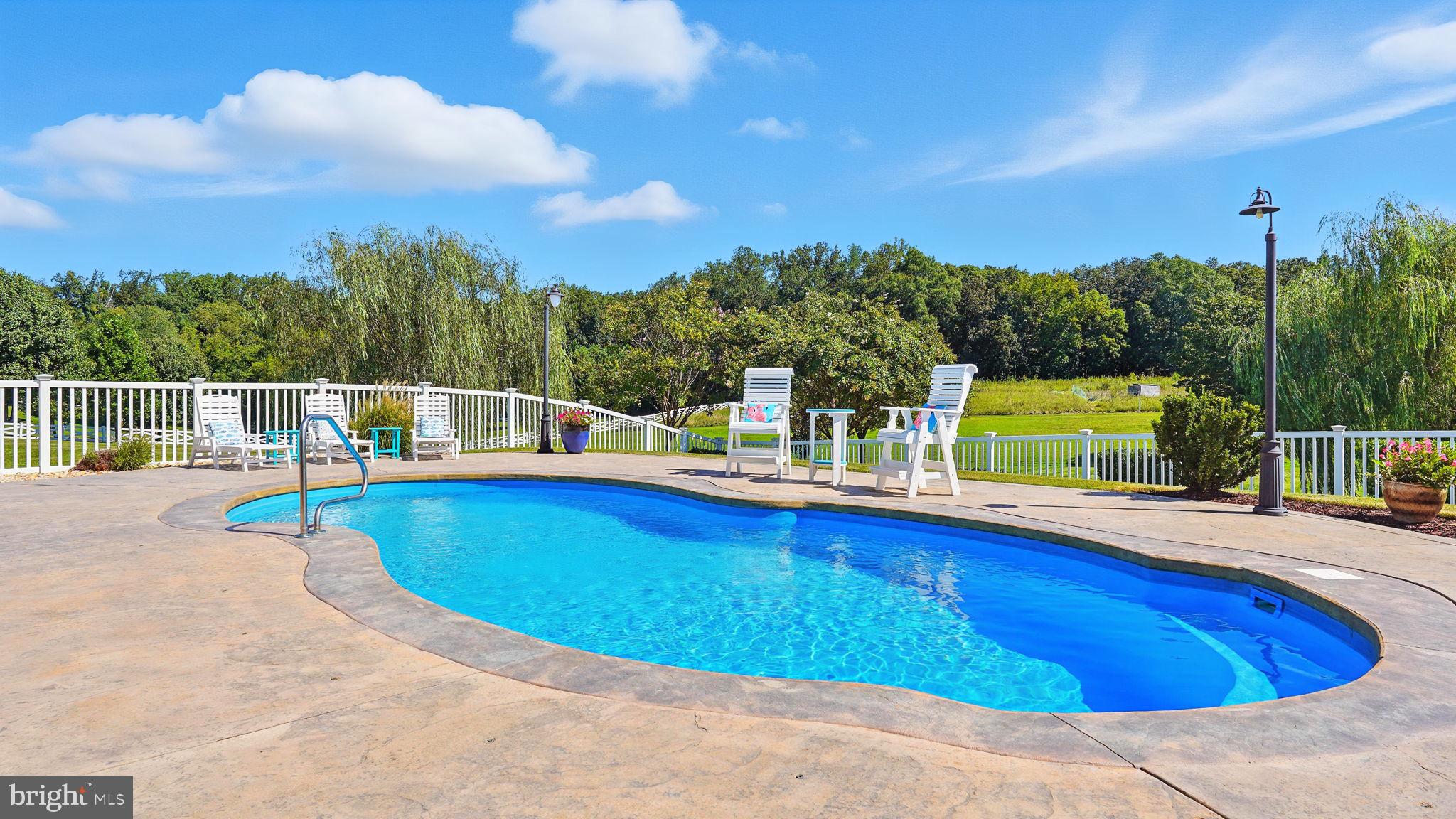 9910 Agnes Lane Spotsylvania, VA 22553 - Photo 3 of 106 a view of a swimming pool with a patio and a yard