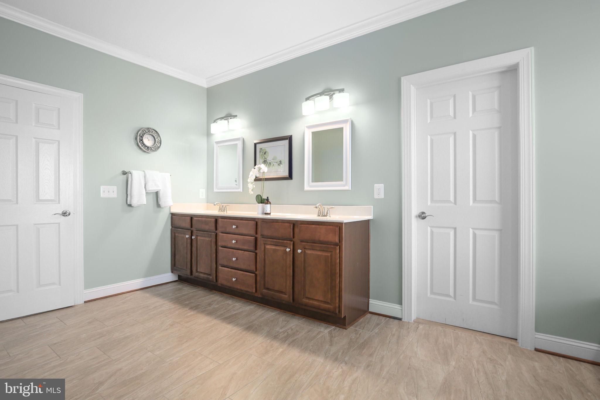 9910 Agnes Lane Spotsylvania, VA 22553 - Photo 42 of 106 a spacious bathroom with a double vanity sink a mirror and a