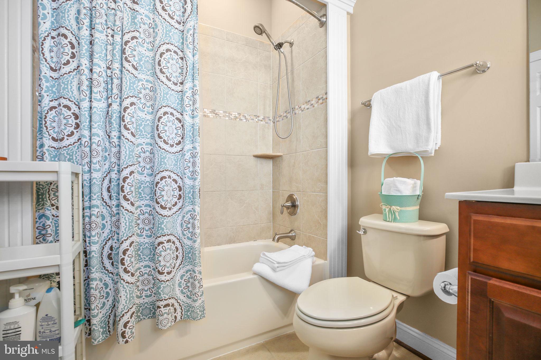 9910 Agnes Lane Spotsylvania, VA 22553 - Photo 59 of 106 a white toilet sitting next to a bathroom sink