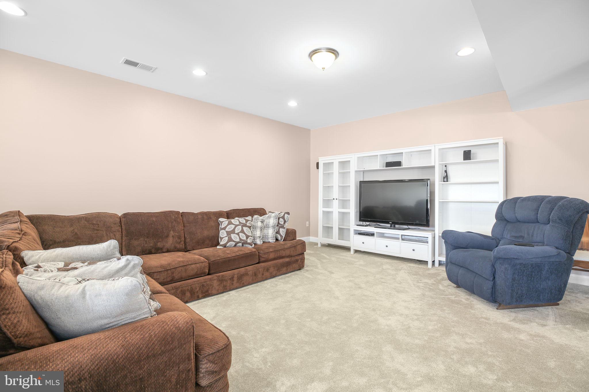 9910 Agnes Lane Spotsylvania, VA 22553 - Photo 65 of 106 a living room with furniture and a flat screen tv