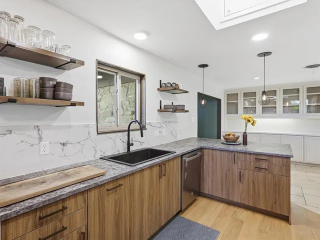 a kitchen with a sink stove and cabinets