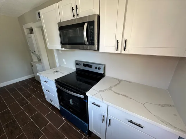 a kitchen with a stove microwave and sink