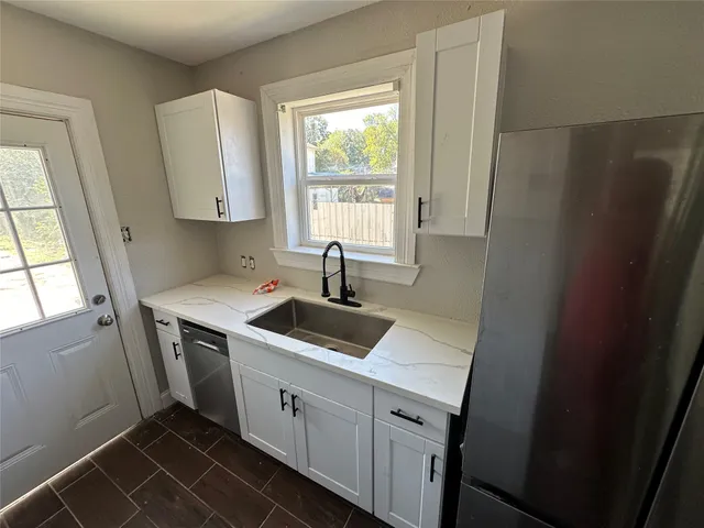 a kitchen with a sink and a refrigerator