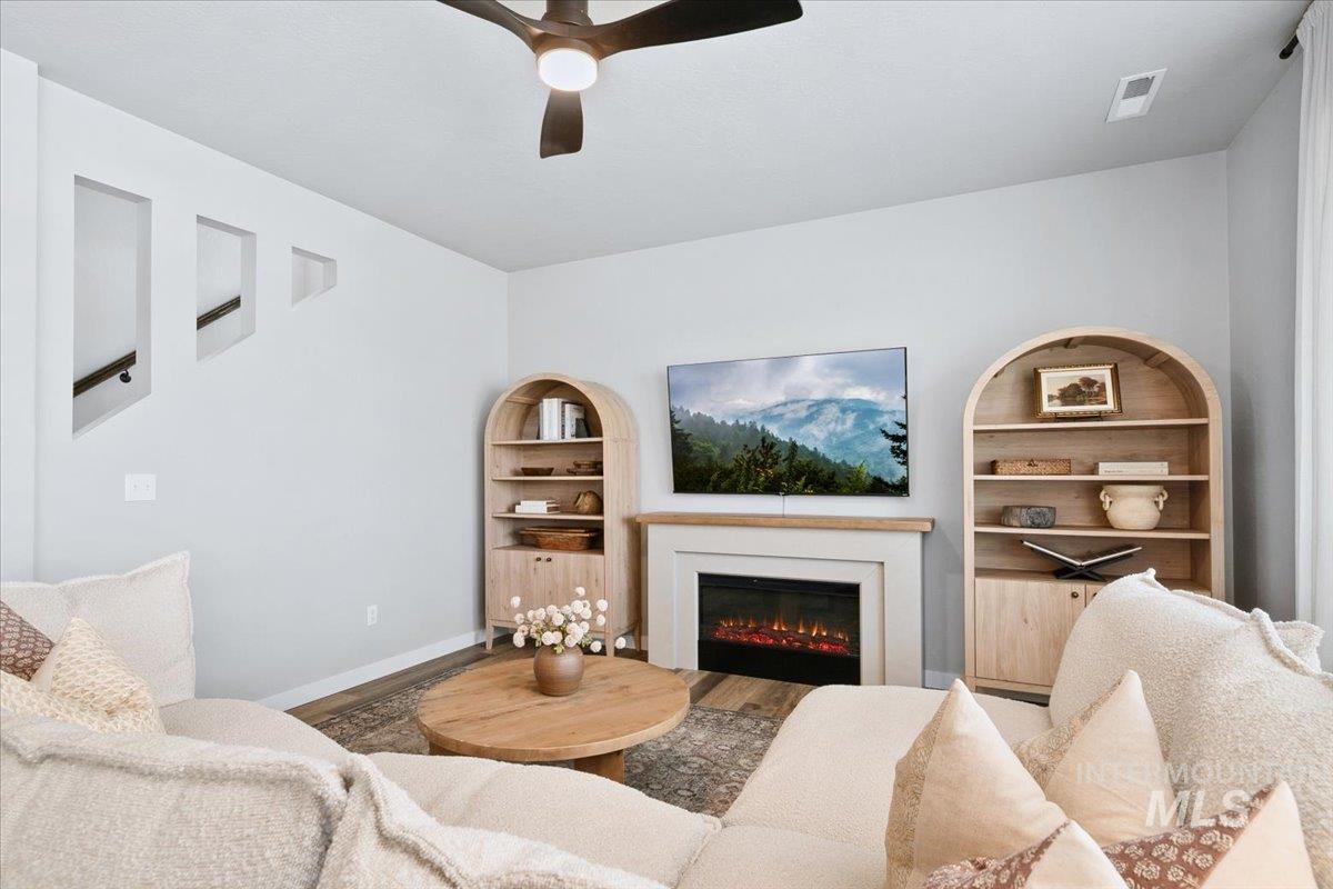 4215 North Pindus Avenue Meridian, ID 83646 - Photo 14 of 46 Living area featuring a ceiling fan and u-shaped stairway to upper bonus, bedrooms, laundry room and storage