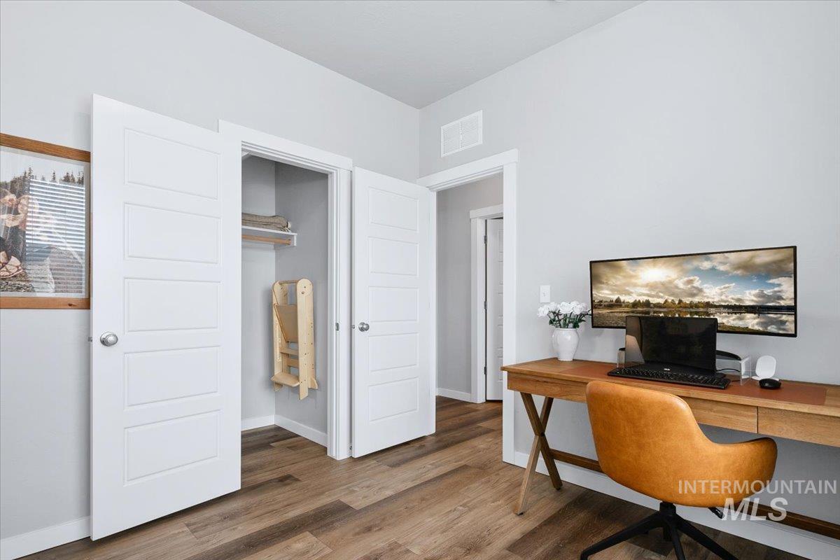 4215 North Pindus Avenue Meridian, ID 83646 - Photo 16 of 46 4th bedroom or office on main floor featuring LVP floors and a walk-in under-stair closet