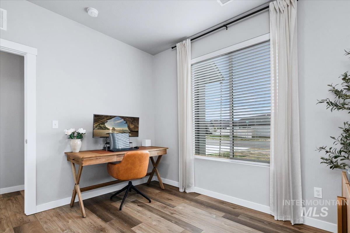 4215 North Pindus Avenue Meridian, ID 83646 - Photo 18 of 46 4th bedroom or office on main floor featuring LVP floors and a walk-in under-stair closet
