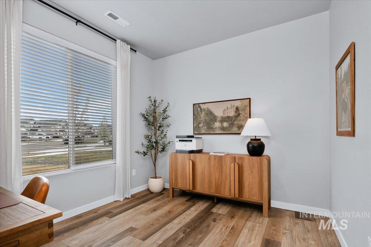 4215 North Pindus Avenue Meridian, ID 83646 - Photo 19 of 46 4th bedroom or office on main floor featuring LVP floors and a walk-in under-stair closet