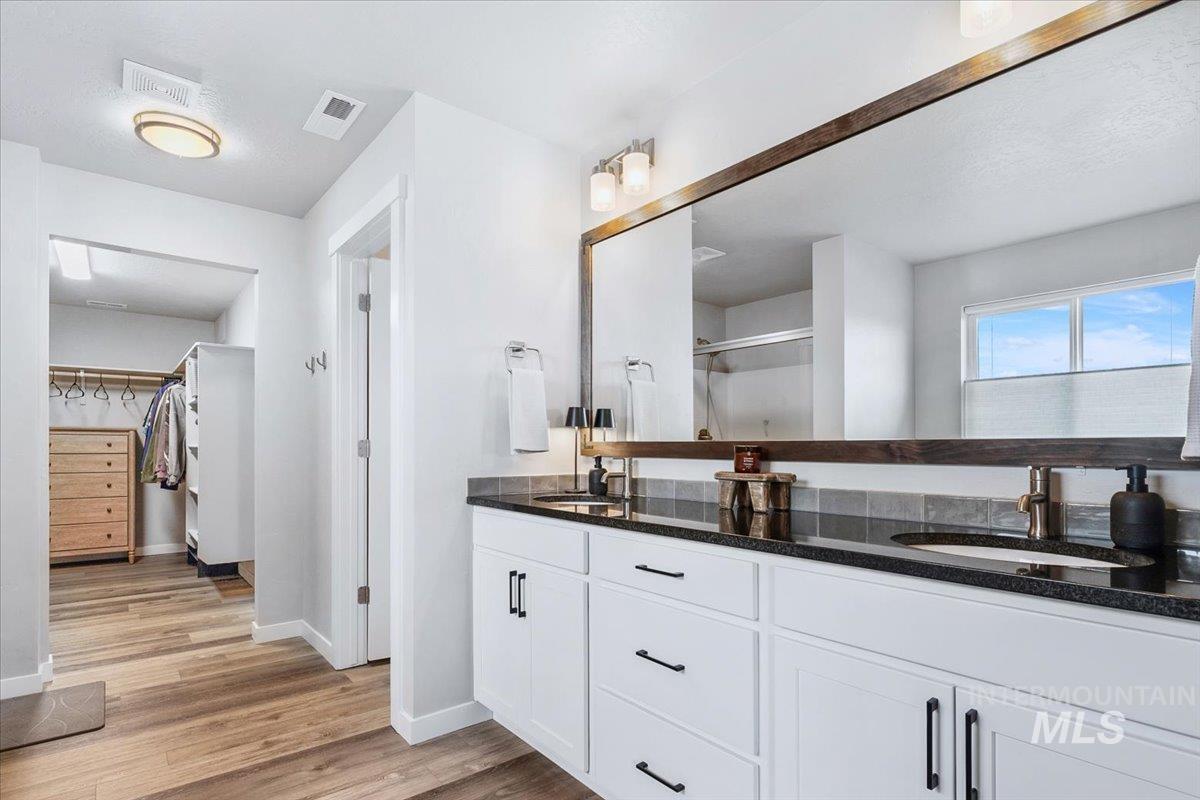 4215 North Pindus Avenue Meridian, ID 83646 - Photo 26 of 46 Bathroom with double vanity, LVP, a water closet and walk-in clothes closet