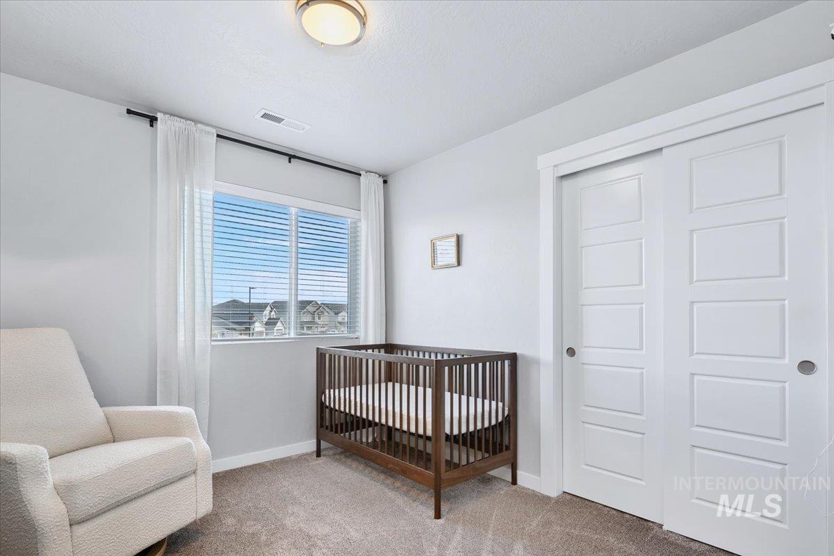 4215 North Pindus Avenue Meridian, ID 83646 - Photo 30 of 46 Bedroom featuring light colored carpet and a closet