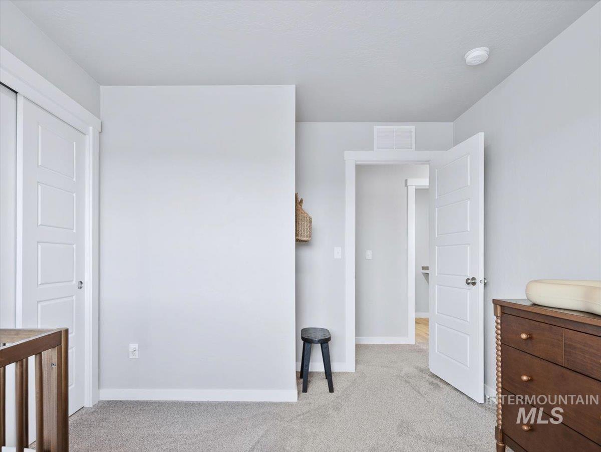 4215 North Pindus Avenue Meridian, ID 83646 - Photo 31 of 46 Bedroom with light carpet