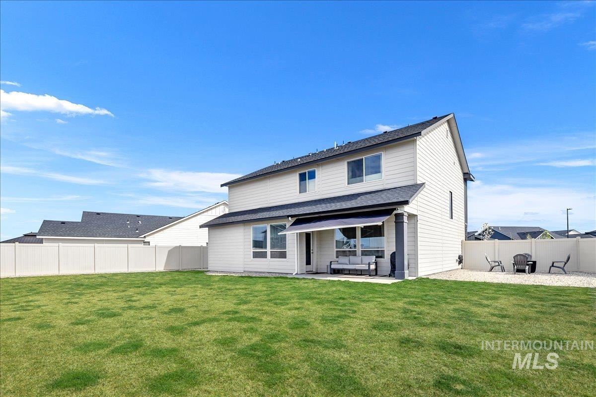 4215 North Pindus Avenue Meridian, ID 83646 - Photo 45 of 46 Rear view of house with a patio area, an outdoor hangout area, and a large fenced back yard