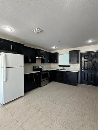 a large kitchen with a large counter top appliances and cabinets