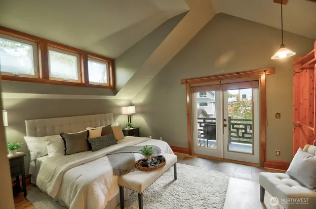 a bedroom with a large bed and a window