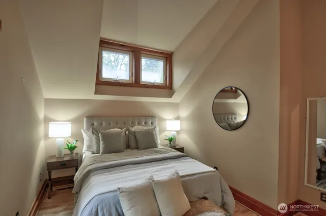 a bedroom with a bed and a window